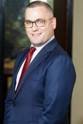 A photo of a man in business dress to the waist down, an example of a bad crop for a LinkedIn headshot.