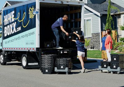An image of a people loading items into a moving truck.