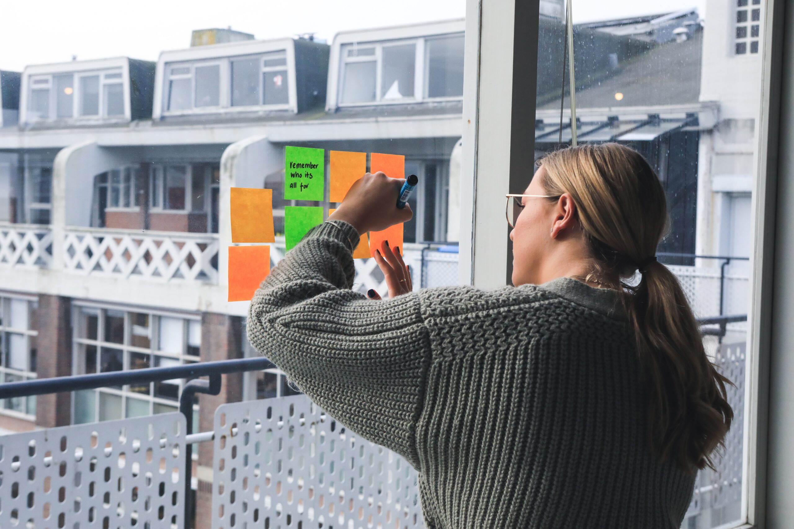 person writing on post -its