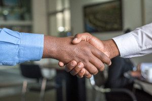 A photo of two people's hands in a handshake.