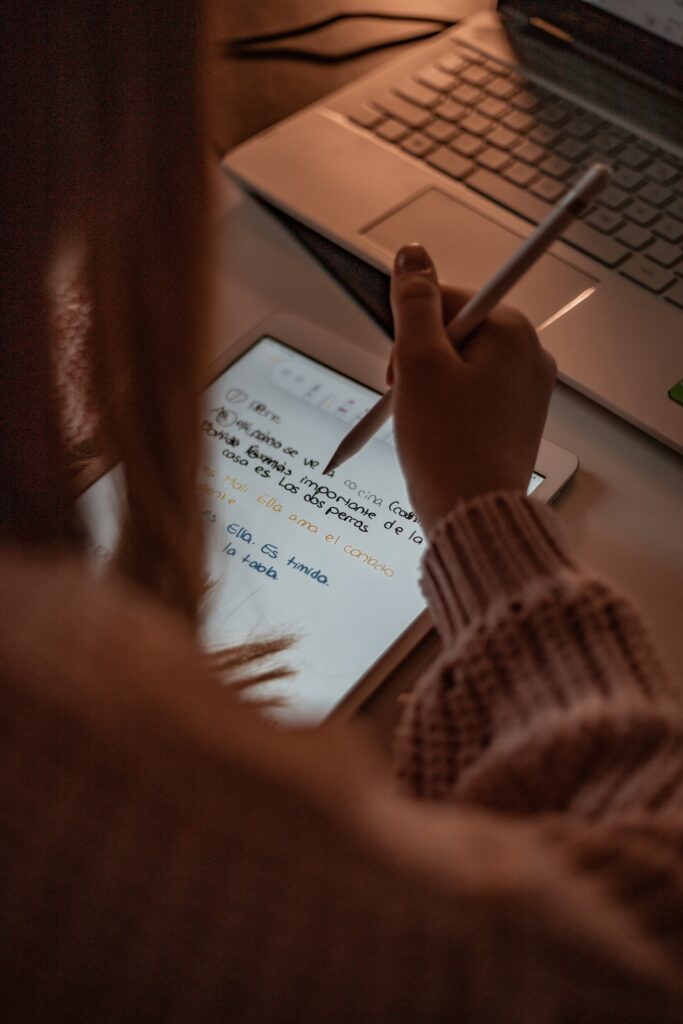 person writing in spanish on an iPad