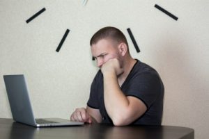 A stock photo of a man looking frustratedly at a laptop. Photo by Bermix Studio on Unsplash.