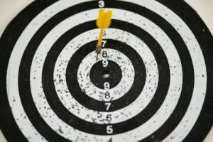 An image of a dart striking close to the bullseye on a dart board, illustrating the importance of writing a target resume as a resume trend for 2021. Photo by Engin Akyurt from Pexels.