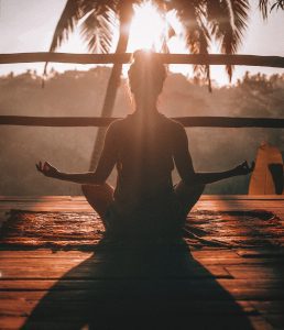 Person meditating. Photo by Jared Rice on Unsplash