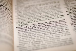 Dictionary page. Photo by Romain Vignes on Unsplash for article on resume clichés