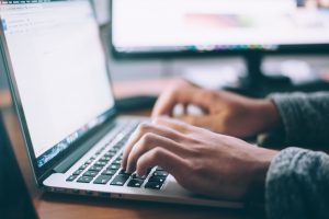 person at computer. Photo by Glenn Carstens-Peters on Unsplash