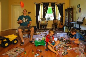 Man juggling with kids. Photo by Mick Haupt on Unsplash. 