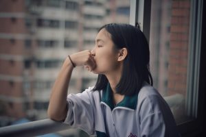 woman looking out window. Photo by 胡 卓亨 on Unsplash