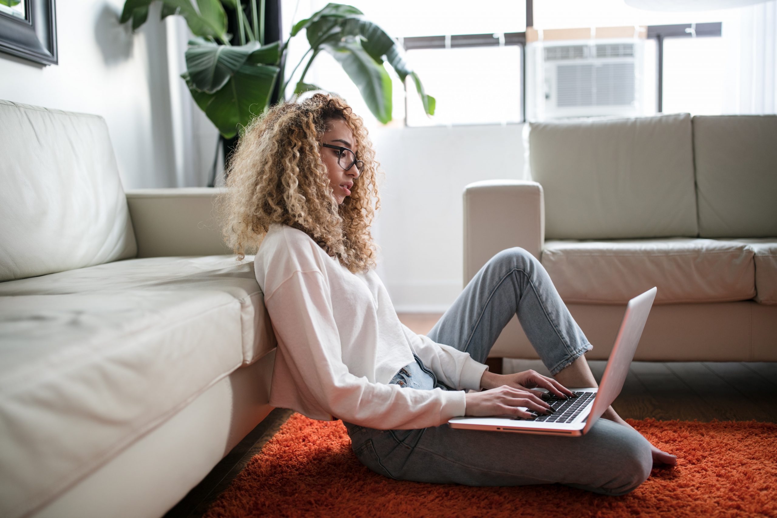 Woman at a computer using bold and italics on resume.