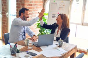 two people high-fiving: ask colleagues who have praised you for linkedin recommendations. Photo by krakenimages on Unsplash