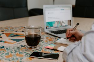 person reading job description on computer.  Photo by Kaleidico on Unsplash