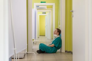 nurse sitting on the floor. Photo by Vladimir Fedotov on Unsplash