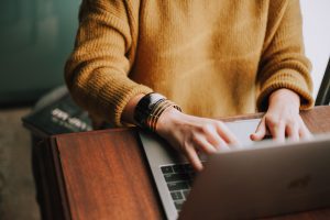 Person saving a resume on a computer using a good resume file name.Photo by Christin Hume on Unsplash