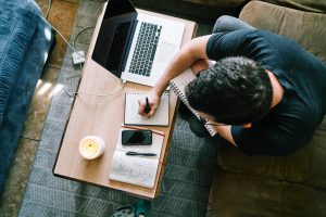 Man writing notes. Photo by ConvertKit on Unsplash   