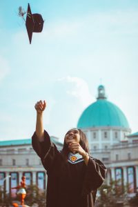 college graduate throwing hat