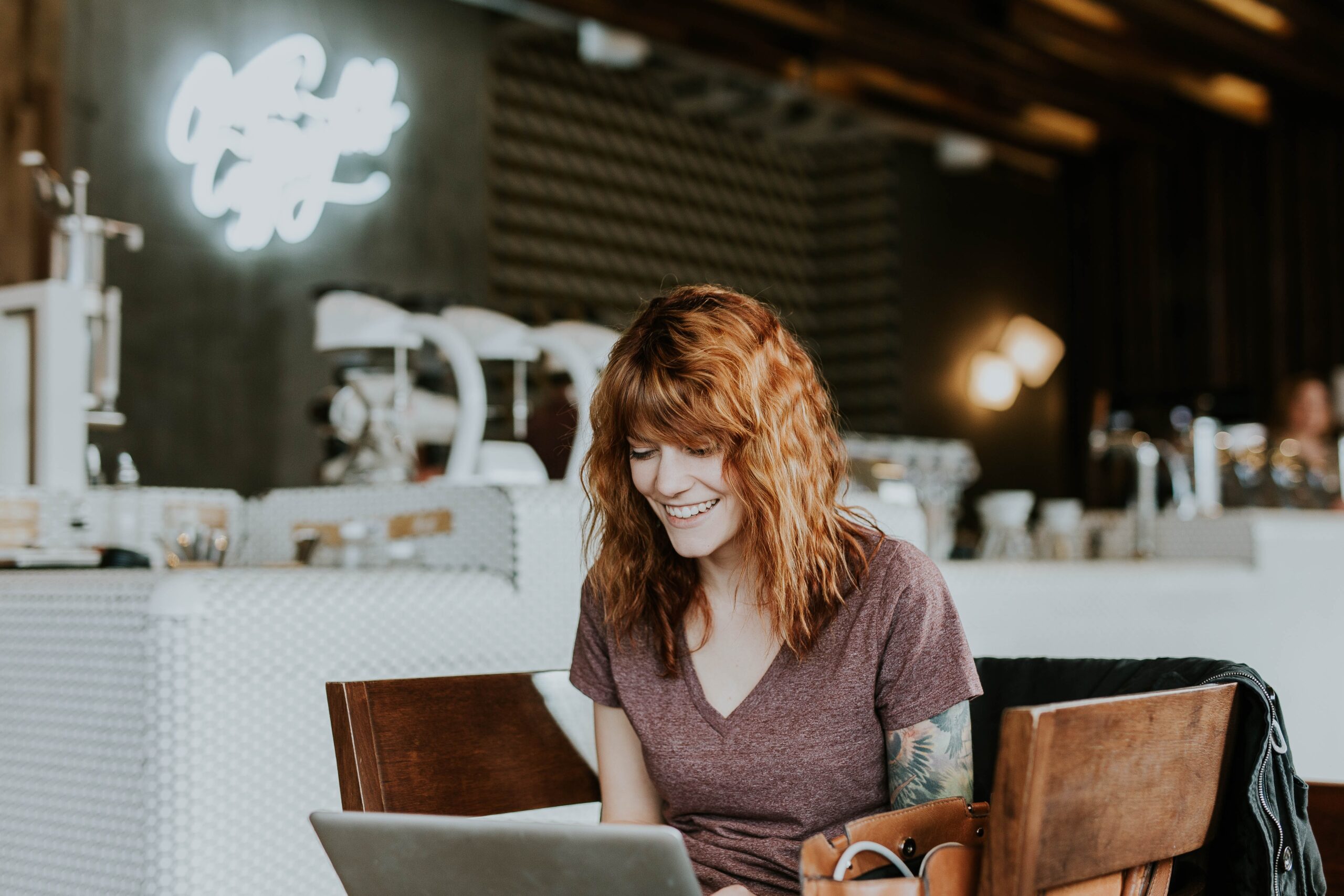 woman smiling at computer because she wrote a great cover letter outline