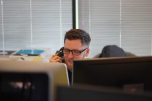 man on phone and computer