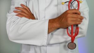 person in lab coat with stethoscope 