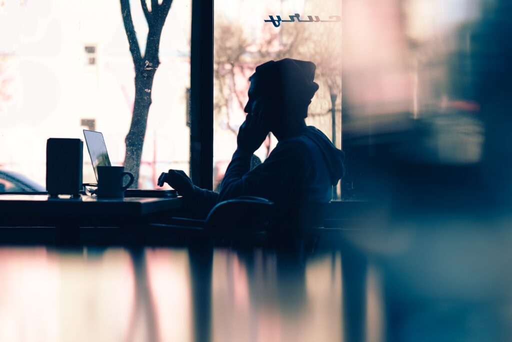 side view of a person on the computer in the distance